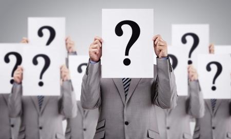 People-Wearing-Grey-Suits-Holding-A-Big-Question-Marks-Over-Face