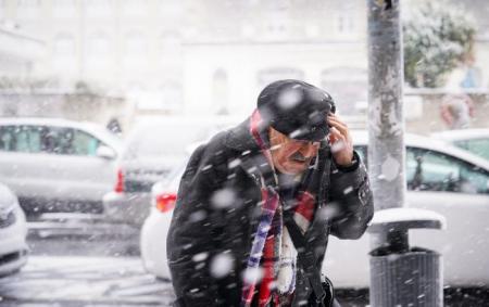 _zima_snigopad_viter_hurtovina_dyadechko_u_palto_y_kapturi_z_vusami_sharfom_i_v_okulyarah_prikriva_18.02.26